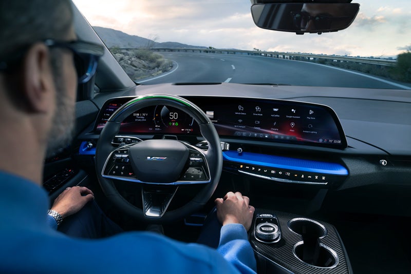 Front View of the 2026 OPTIQ-V Driving Through the Dusk Utilizing its Headlights | Integrity Cadillac in Chattanooga TN