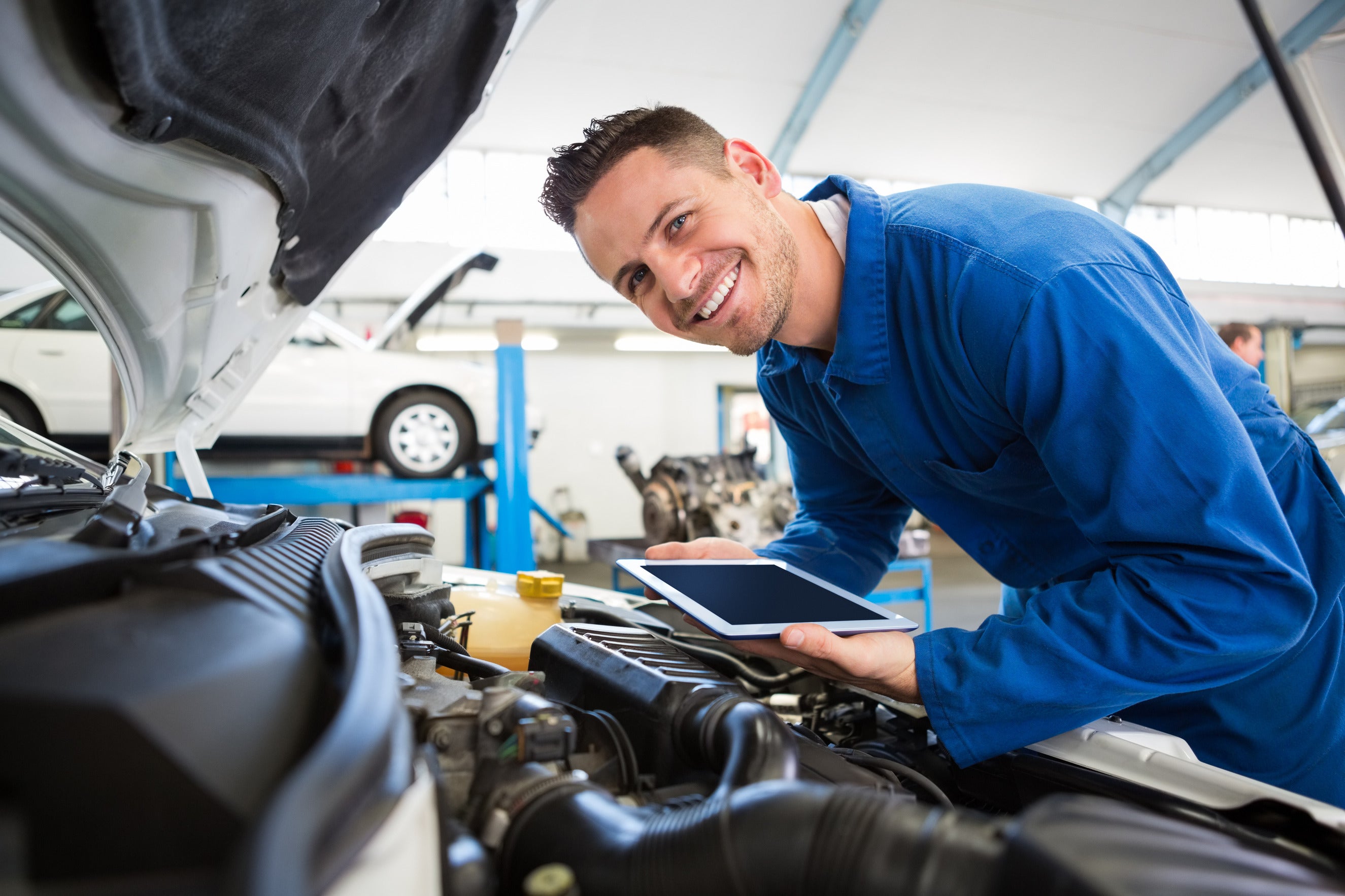 Service technician with blue shirt holding ipad 